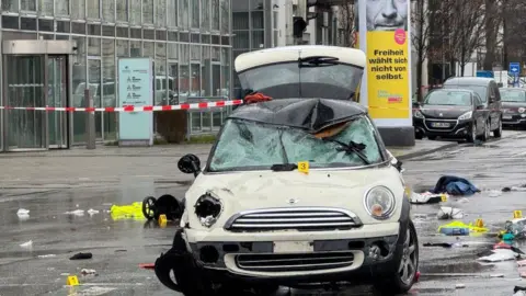 Getty Images The damaged Mini car which collided with the crowd in Munich
