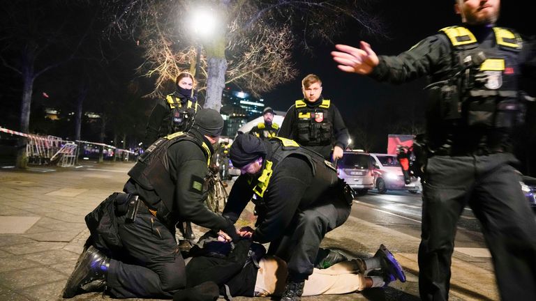 Police detained a man at the memorial. Pic: AP