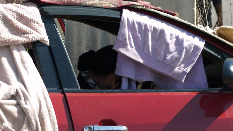 photo label "woman in her car"  SN eyewitness from Stuart Ramsay about Syrian Alawites which features:  Hmeimim air base, home to the Russian military in Syria; mass grave in Al-Sanobar; head of General Security, Mustafa Kunefate; various GVs of locals and case studies