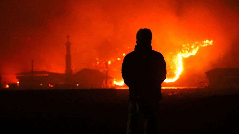 A resident looks on as a wildfire devastates the area in Andong, South Korea, March 25, 2025.   Yonhap via REUTERS   THIS IMAGE HAS BEEN SUPPLIED BY A THIRD PARTY. NO RESALES. NO ARCHIVES. SOUTH KOREA OUT. NO COMMERCIAL OR EDITORIAL SALES IN SOUTH KOREA.