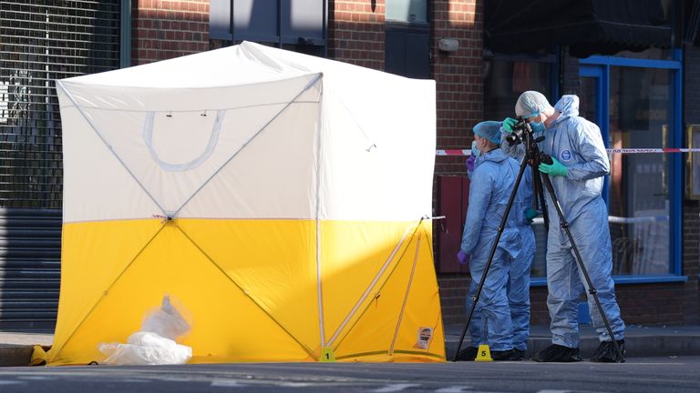 Forensic officers at the scene in Brixton Road.  Pic: PA