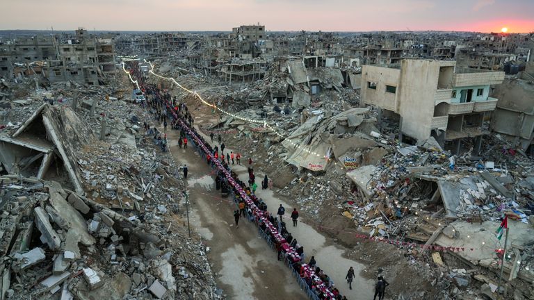 Palestinians gather among the rubble for iftar, the fast-breaking meal, on the first day of Ramadan in Rafah, in the south of the enclave.  Pic: AP/Abdel Kareem Hana