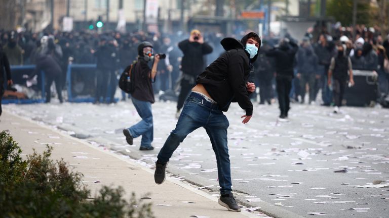 A demonstrator throws an object during a protest outside the Greek parliament, marking the second anniversary of the country's worst railway disaster, while an investigation continues, in Athens, Greece, February 28, 2025. REUTERS/Florion Goga