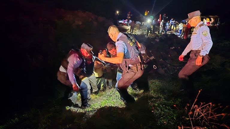 Adverse conditions were said to have hindered search efforts. Here emergency services carry a stretcher across the coast.  Pic: Honduras National Police