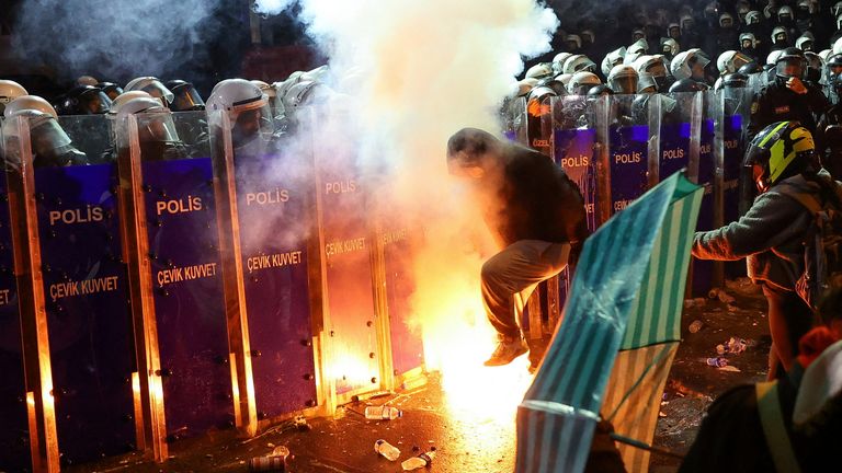Riot police officers stand in formation next to demonstrators during a protest against the detention of Istanbul Mayor Ekrem Imamoglu, in Istanbul, Turkey, March 22, 2025. REUTERS/Murad Sezer TPX IMAGES OF THE DAY