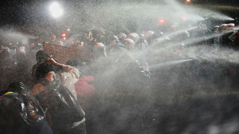 Protesters clash with riot police during a protest against the arrest of Istanbul's Mayor Ekrem Imamoglu, in Istanbul, Turkey, Saturday, March 22, 2025. (AP Photo/Francisco Seco)