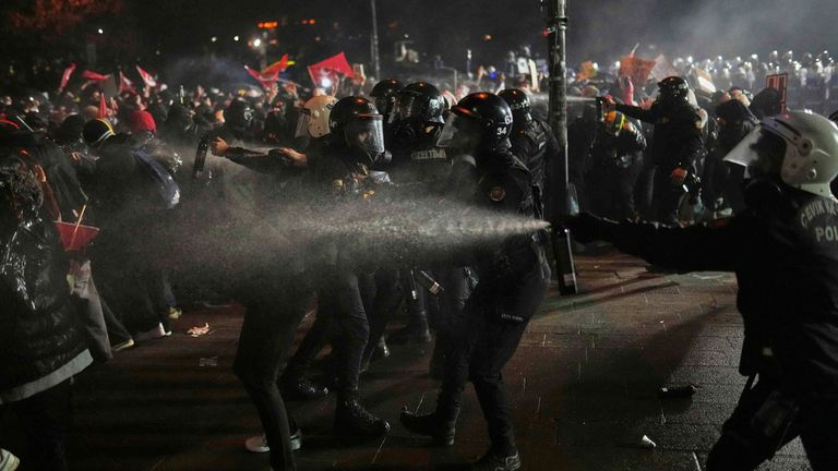 Riot police officers clash with protesters during a protest after Istanbul's Mayor Ekrem Imamoglu was arrested and sent to prison, in Istanbul, Turkey, Sunday, March 23, 2025. (AP Photo/Francisco Seco)