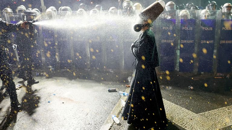Police officers pepper spray a demonstrator wearing dervish clothes, during in Istanbul, Turkey.  Pic: Reuters
