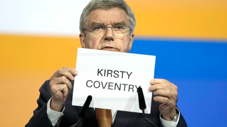 IOC President Thomas Bach holds up the name of Kirsty Coventry as she is announced as the new IOC President.  Pic: AP
