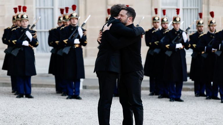 Emmanuel Macron and Volodymyr Zelenskyy  hug as they meet for a meeting ahead of a peace and security conference in Paris.  Pic: Reuters