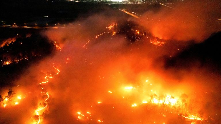 Smoke and flames rise from a wildfire in Andong, South Korea  Pic: Yonhap/Reuters  Pic: Yonhap/Reuters