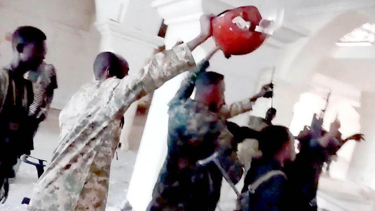Sudanese army members celebrate inside the presidential palace.  Pic: Reuters
