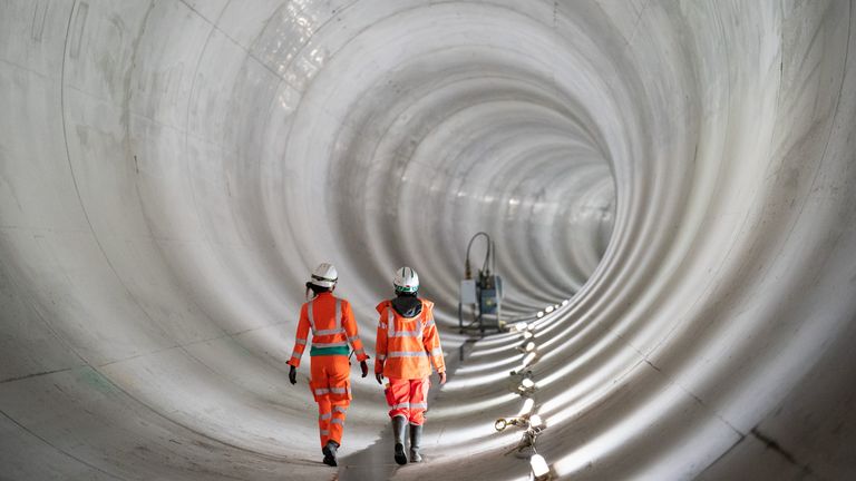 Construction workers walk in a completed section of the main tunnel of London's new 25km long Thames Tideway Tunnel or 'Super Sewer', nearly 70m below ground. Picture date: Friday April 29, 2022.  Read less    Picture by: Dominic Lipinski/PA Archive/PA Images  Date taken: 29-Apr-2022