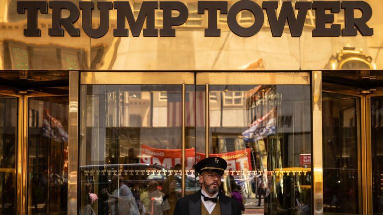 A reflection of the supporters of former President Donald Trump is seen at the entrance of Trump Tower, Sunday, July 14, 2024, in New York. (AP Photo/Yuki Iwamura)