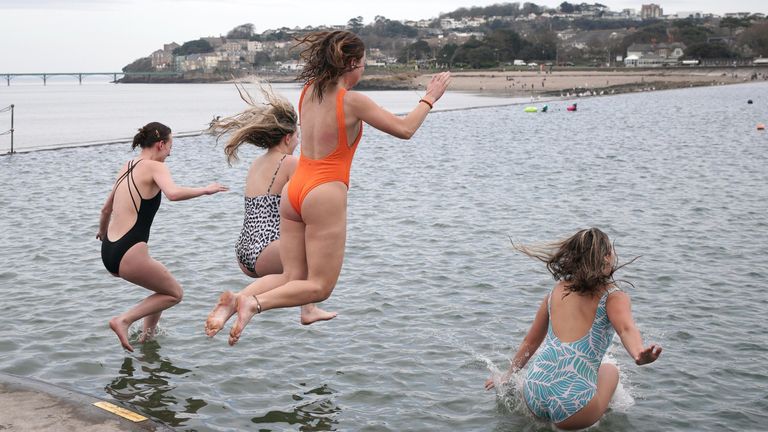 People enjoy the warm weather at Clevedon Marine Lake in Clevedon. Parts of the UK are expected to be warmer this weekend than holiday hotspots including the Balearic islands, Costa del Sol and the Amalfi Coast. Picture date: Saturday March 8, 2025. PA Photo. Photo credit should read: Ben Birchall/PA Wire