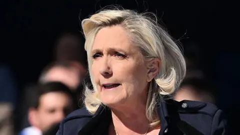 Getty Images French far-right leader Marine Le Pen speaks at a rally in support of her, in Paris, France on 6 April