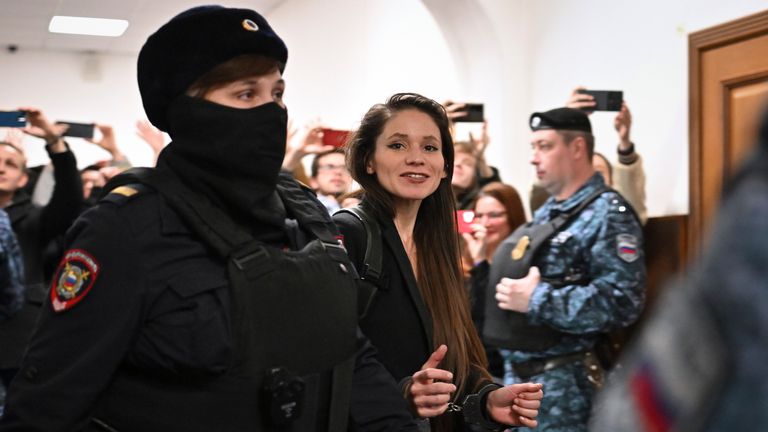 Antonina Favorskaya is escorted by a police officer to the courtroom in the Basmanny District Court in Moscow, Russia, Friday, March 29, 2024. A court in Moscow makes a decision on measure of restrain to journalist Antonina Favorskaya in the case of her connection with the FBK, the Anti-Corruption Foundation set up by Russian opposition leader Alexei Navalny in 2011 and declared extremist and closed in 2021. (AP Photo/Dmitry Serebryakov)