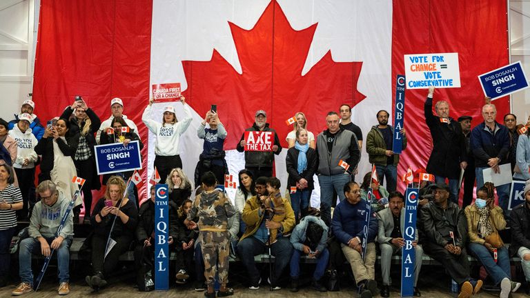 People listen as Conservative Party of Canada leader Pierre Poilievre speaks at an election campaign event in Brampton, Ontario, Canada April 9, 2025. REUTERS/Carlos Osorio