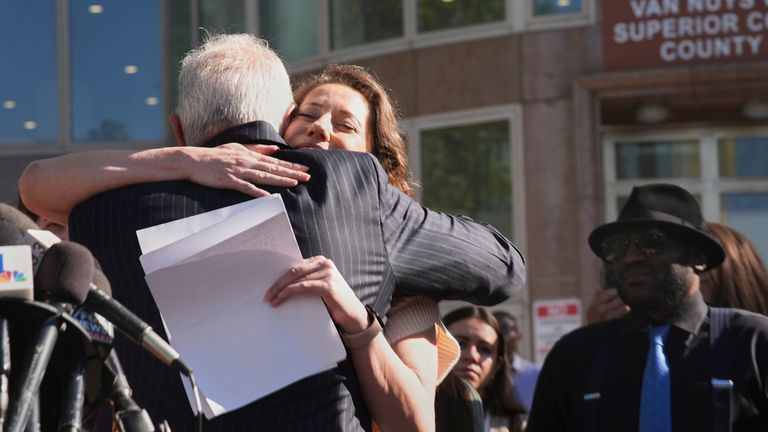Anamaria Baralt, cousin of Erik and Lyle Menendez, hugs attorney Mark Geragos after a hearing in the brothers' case Friday, April 11, 2025, in Los Angeles. (AP Photo/Damian Dovarganes)