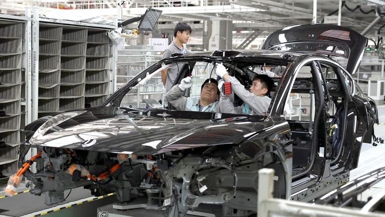 Employees work on the production line at a factory of Chinese electric vehicle (EV) maker Nio in Hefei, Anhui province, China April 2, 2025. REUTERS/Florence Lo