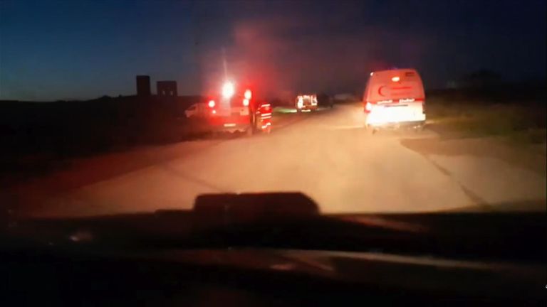 The three vehicles are seen with red flashing lights in the footage