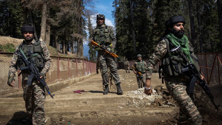 Indian security force personnel stand guard at the site of a suspected militant attack on tourists in Pahalgam.  Pic: Reuters/Adnan Abidi