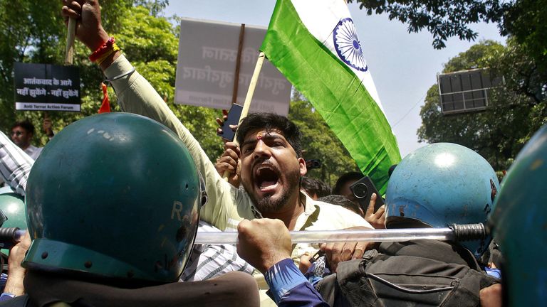 A demonstrator shouts slogans as he is stopped by police during a protest near the Pakistan High Commission in New Delhi, India.  Pic: Reuters/Stringer