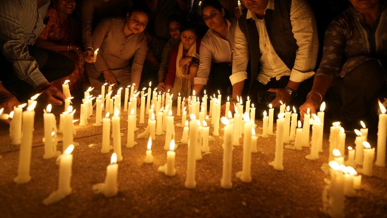 People place candles after a march against the killing of tourists by militants near Pahalgam in Indian controlled Kashmir, in Ahmedabad, India, Thursday, April 24, 2025. (AP Photo/Ajit Solanki)