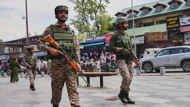 Indian paramilitary soldiers patrol a busy market in Srinagar, Indian-controlled Kashmir. Pic: AP