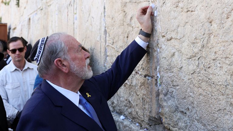 Ambassador to Israel Mike Huckabee places a note, which he says is from U.S. President Donald Trump, in the cracks of the Western Wall, Judaism's holiest prayer site, in Jerusalem's Old City, April 18, 2025. REUTERS/Ronen Zvulun TEMPLATE OUT