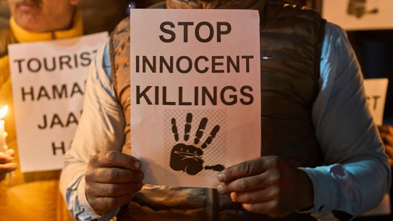 Kashmiri men hold candles and placards as they condemn the tourists killing during a protest in Srinagar, Indian controlled Kashmir, Thursday, April. 24, 2025. (AP Photo/Dar Yasin)
