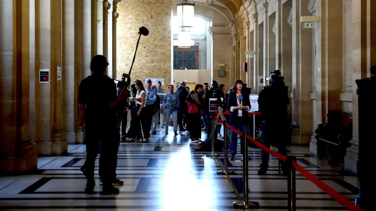 Journalists work in a corridor of the courthouse on the first day of the trial of 10 people accused of stealing millions of dollars worth of jewellery from Kim Kardashian, who was held at gunpoint in her apartment during Paris fashion week in 2016, a trial known as the "Rue Tronchet" affair, at the Court of Appeal of Paris, France, April 28, 2025. REUTERS/Sarah Meyssonnier