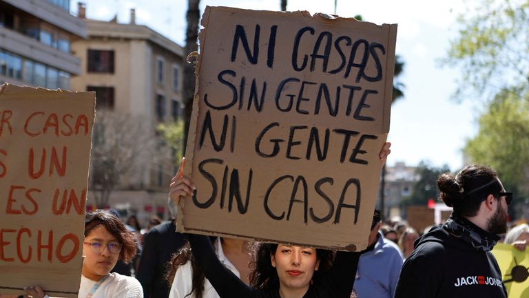 'Neither houses without people, nor people without houses' reads a protest banner in a march against housing prices and the impact of tourism on the residents of the Balearic Islands, in Palma, Mallorca, Spain, April 5, 2025. REUTERS/Francisco Ubilla