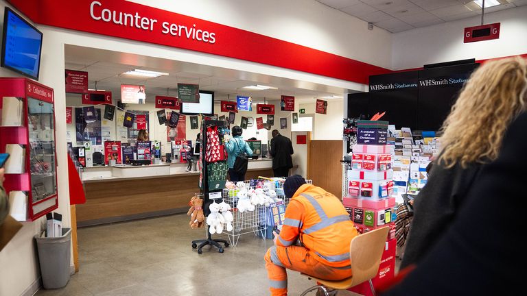 People inside a branch of the Post Office in Paddington,.  Pic: PA