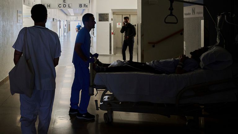 A medical staffer relocates a patient during a nationwide power outage in Pamplona, northern Spain, Monday, April 28, 2025. (AP Photo/Miguel Oses)