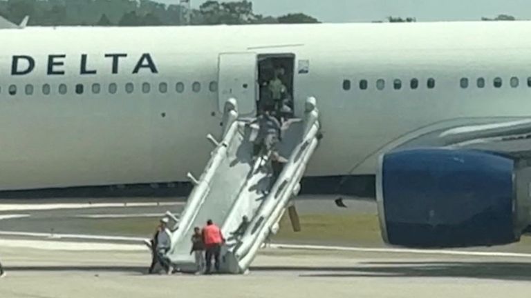 People evacuate a Delta plane due to an engine fire in Orlando, Florida, United States, April 21, 2025, in this video screengrab obtained from social media. @dylangwall via X/via REUTERS THIS IMAGE HAS BEEN SUPPLIED BY A THIRD PARTY. MANDATORY CREDIT. NO RESALES. NO ARCHIVES.