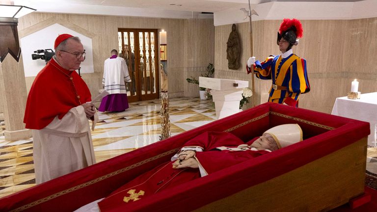 SENSITIVE MATERIAL. THIS IMAGE MAY OFFEND OR DISTURB Cardinal Pietro Parolin, the Vatican's secretary of state, stands near the body of Pope Francis, placed in an open casket during the rite of the declaration of death in Santa Marta residence at the Vatican, April 21, 2025. Vatican Media/­Handout via REUTERS ATTENTION EDITORS - THIS IMAGE WAS PROVIDED BY A THIRD PARTY. TPX IMAGES OF THE DAY