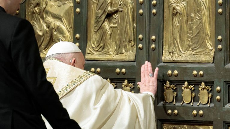 Pope Francis opens the Holy Door to mark the opening of the 2025 Catholic Holy Year, or Jubilee, in St. Peter's Basilica, at the Vatican, December 24, 2024. REUTERS/Remo Casilli/Pool