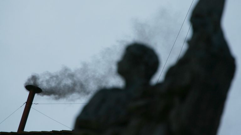 A statue of an angel is silhouetted in front of black smoke rising from the chimney above the Sistine Chapel. A statue of an angel is silhouetted in front of black smoke rising from the chimney above the Sistine Chapel in the Vatican, indicating no decision has been made after the first vote for the election of a new pope, April 18, 2005. The 115 eligible cardinals began the papal conclave on Monday evening to elect a new pope following the death of Pope John Paul II. REUTERS/Max Rossi