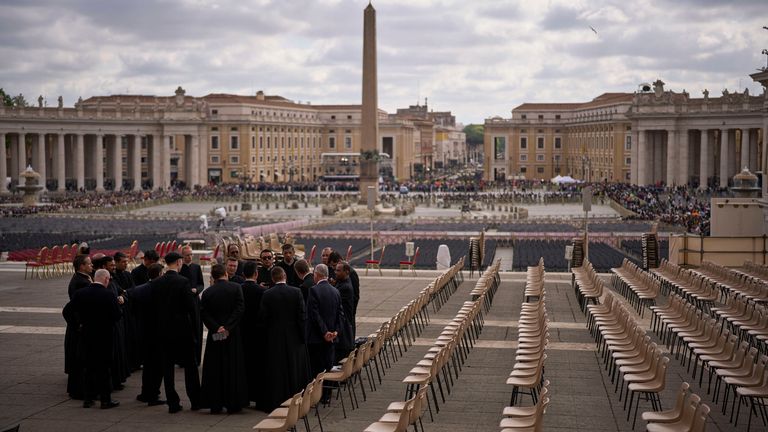 Priests and security personnel gather in St Peter's Square ahead of the funeral. Pic: AP
