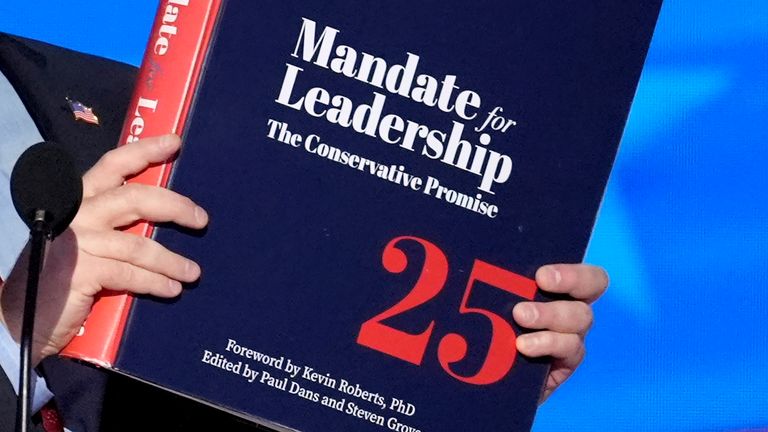 FILE - A copy of Project 2025 is held during the Democratic National Convention, Aug. 21, 2024, in Chicago. (AP Photo/J. Scott Applewhite, File)