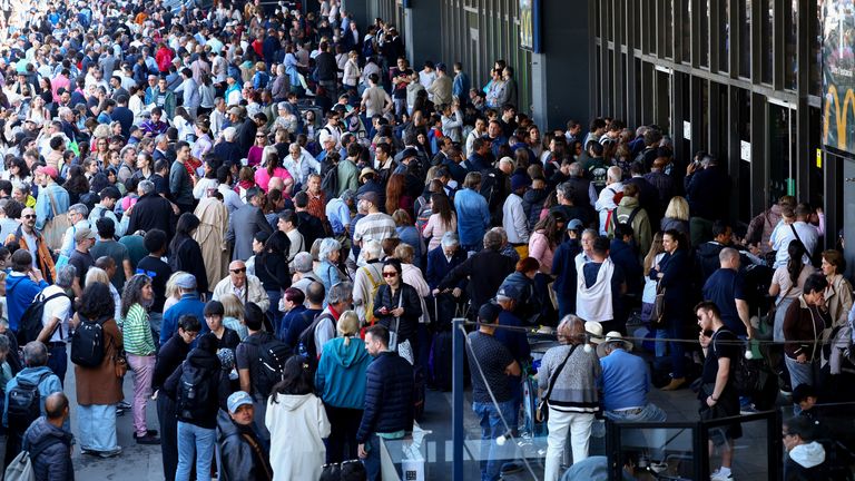 People gather outside Barcelona-Sants train station during a power outage. Pic: Reuters