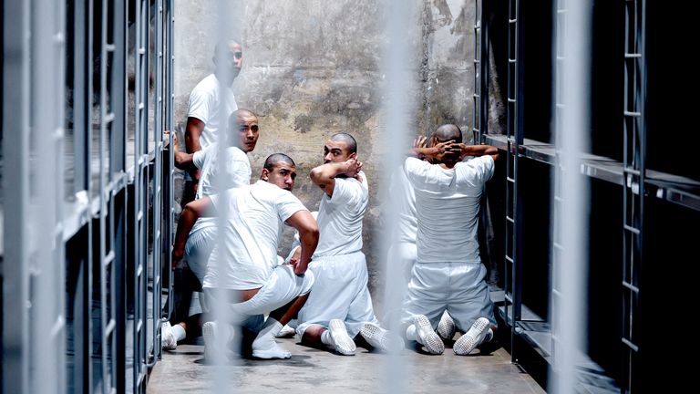 Alleged members of the Venezuelan gang Tren de Aragua and the MS-13 gang, recently deported by the U.S. government, look on from inside a jail at the Terrorism Confinement Center (CECOT) prison, in Tecoluca, El Salvador.  Pic: Secretaria de Prensa de la Presidencia/Reuters