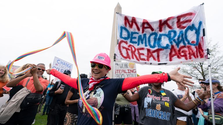 A demonstrator twirls a ribbon during a "Hands Off!" protest against President Donald Trump at the Washington Monument in Washington, Saturday, April 5, 2025. (AP Photo/Jose Luis Magana)