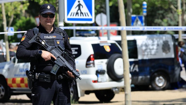 A police officer stands guard near the spot where former Ukrainian politician Andriy Portnov, according to the Spain's Interior Ministry, was shot and killed by unidentified gunmen, outside a school in a wealthy suburb of Madrid, in Madrid, Spain May 21, 2025. REUTERS/Nacho Doce