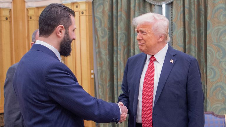 In this photo released by the Saudi Royal Palace, President Donald Trump, right, shakes hands with Syria's interim President Ahmad al-Sharaa, in Riyadh, Saudi Arabia, Wednesday, May 14, 2025. (Bandar Aljaloud/Saudi Royal Palace via AP)