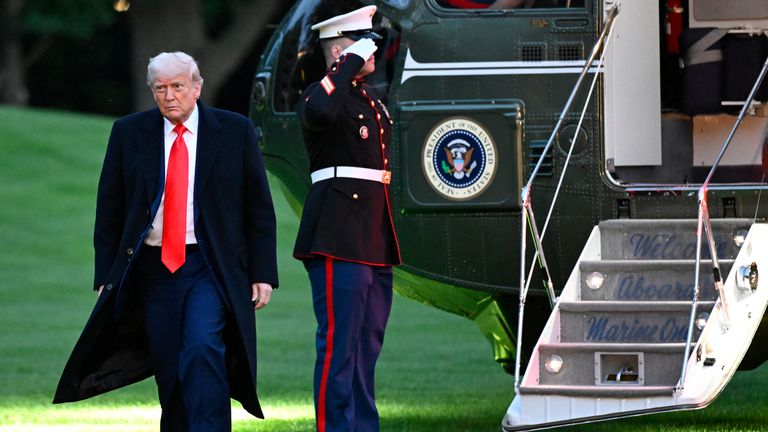 President Donald Trump arrives on the South Lawn of the White House after attending the crypto dinner.  Pic: AP/John McDonnell