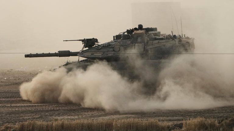 An Israeli tank moves in a staging area in southern Israel, near the border with Gaza, Friday, May 16, 2025. (AP Photo/Maya Alleruzzo)