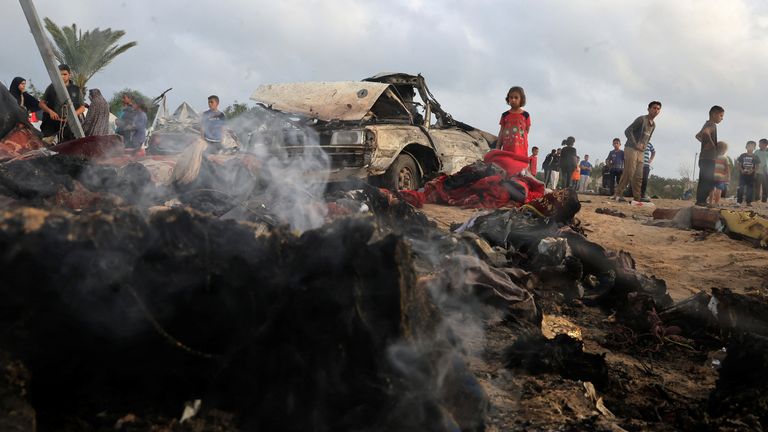 Palestinians inspect the damage at the site of an Israeli strike on a tent camp sheltering displaced people, in Khan Younis, southern Gaza Strip, May 18, 2025. REUTERS/Hatem Khaled
