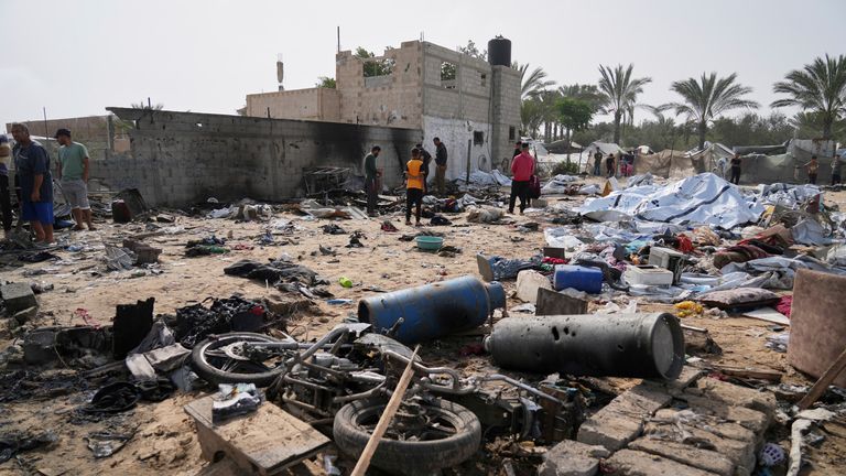 Palestinians inspect the site destroyed by Israeli airstrikes in Khan Younis, Gaza Strip, Sunday, May 18, 2025. (AP Photo/Abdel Kareem Hana)